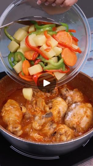 someone is adding vegetables and meat to a pot on the stove with a spatula