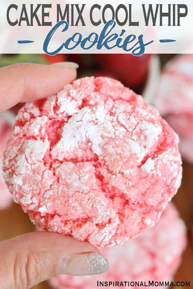 a hand holding up a pink cookie with white powder on it and the words, how to make cake mix cool whip cookies