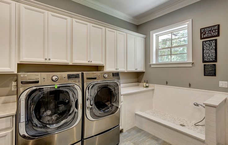 an image of a laundry room with washer and dryer on the right side