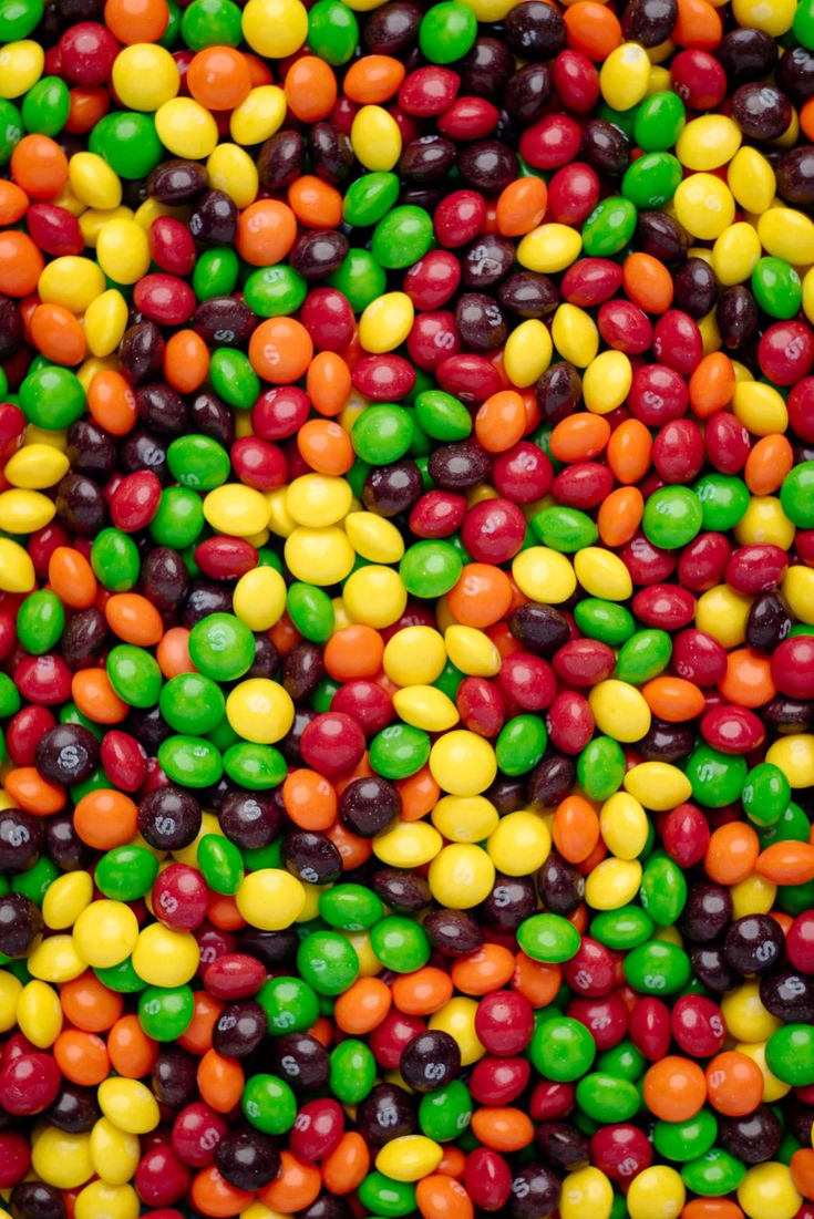 many different colored candies are arranged together