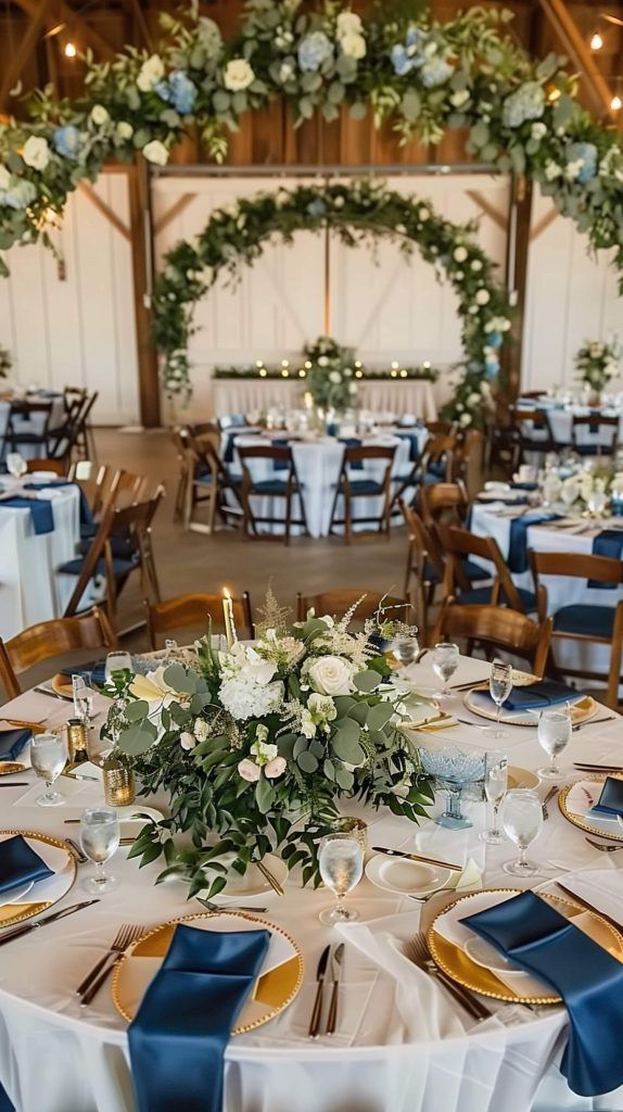 the tables are set up with blue and white linens, gold place settings, and greenery