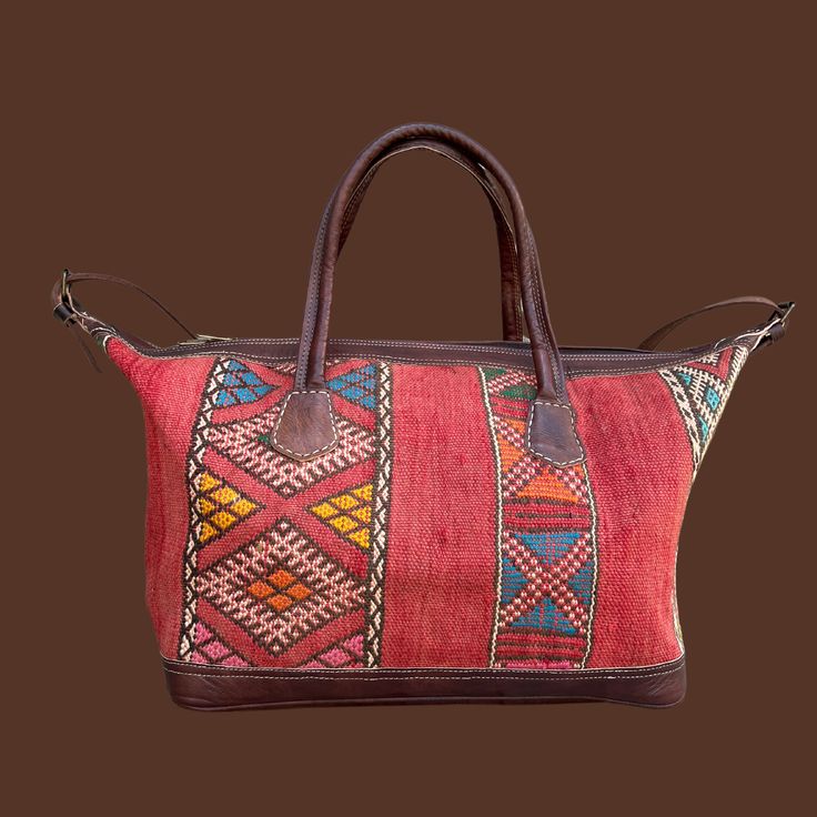 You're going to want to plan a weekend trip just so you can use this beautiful bag! Intertwined's beautifully crafted travel bag is handmade in Morocco from locally tanned leather and vintage, handwoven kilim. Each kilim is one-of-a-kind and handwoven with unique colors and patterns based on the region where it is made. Traditional Rectangular Weekender Bag For Travel, Bohemian Rectangular Bag For Overnight Trips, Bohemian Leather Tote Travel Bag, Travel Woven Satchel, Traditional Tote Travel Bag With Leather Handles, Traditional Travel Tote Bag With Leather Handles, Traditional Tote Weekender Bag For Travel, Traditional Travel Bags With Leather Handles, Brown Bohemian Tote Travel Bag