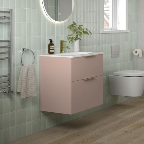 a bathroom with a toilet, sink and mirror next to a radiator in the wall