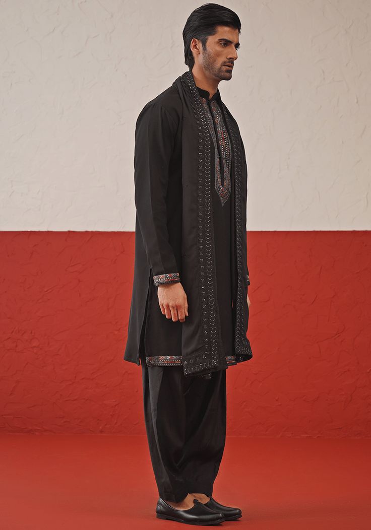 Embrace timeless elegance with Black Kurta. Crafted from luxurious Georgette, the kurta features intricate resham and sequinned embroidery on the yoke, daman, and cuffs. Paired perfectly with matching patiyala pants and an embroidered dupatta. Ideal for Cocktail parties. Composition : Kurta, Patiyala & Dupatta : Viscose Georgette Care: Dry Clean Only and Vacuum Storage This product can be customized for sleeves, length and colour Delivery : 4-6 weeks as the product is hand crafted. Check Size Guide or choose MySize for free customisation (All Sizes above XL can be made at 15% additional cost) For more information and sizes please contact fabiliciousfashion@gmail.com or visit our Copenhagen studio. About the Designer : Welcome to Kalpraag, your destination for exquisite men's ethnic wear th Black Kurta Set, Kurta Set With Dupatta, Black Kurta, Men's Ethnic Wear, Vacuum Storage, Indian Wedding Wear, Embroidered Dupatta, Cocktail Parties, Kurta Set