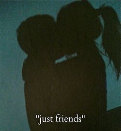 the shadow of two people kissing in front of a blue wall that says, just friends