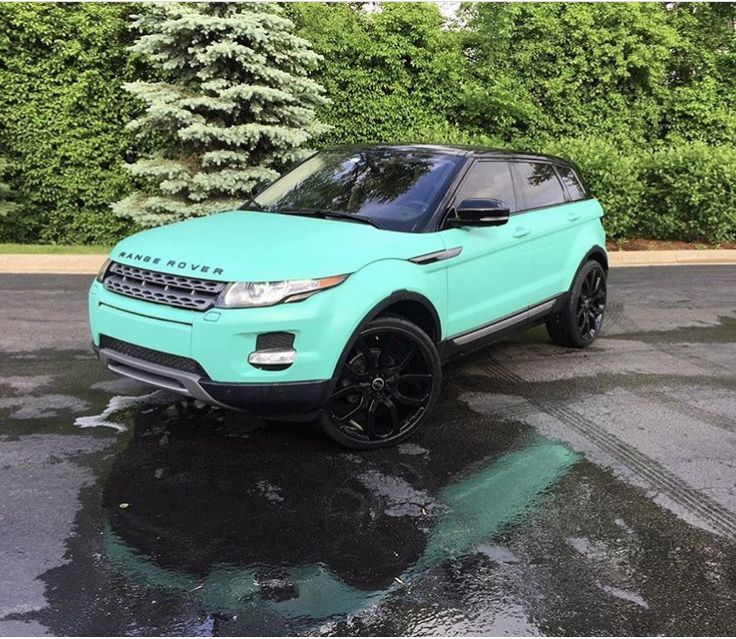 a blue range rover is parked in the parking lot