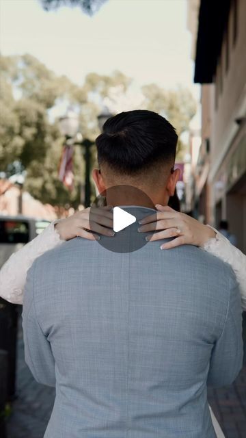 a man and woman embracing each other on the street