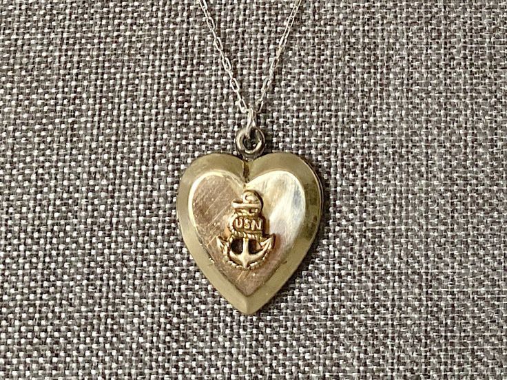 This vintage sweetheart necklace bears a US Navy insignia on a heart-shaped locket. The locket is hallmarked 10K gold-filled sterling from D'Aguanno Bros. The chain is a new, 14K gold-filled, and measures 18 inches. This piece has been restored as close as possible to its original condition, cleaned gently by hand with steam, polishing cloths, and good old-fashioned elbow grease.This vintage item has been loved and cherished by a previous owner, there will be some slight wear or imperfections. I Navy Insignia, Sweetheart Jewelry, Hope Design, Heart Locket, Us Navy, 10k Gold, Grease, Locket, Old Fashioned