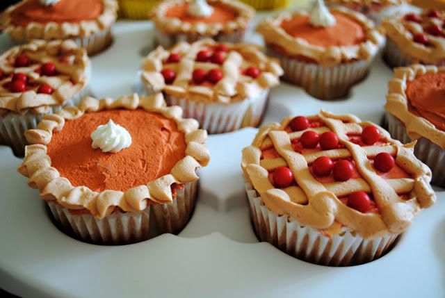 several cupcakes with red and white frosting on a plate in the shape of pies