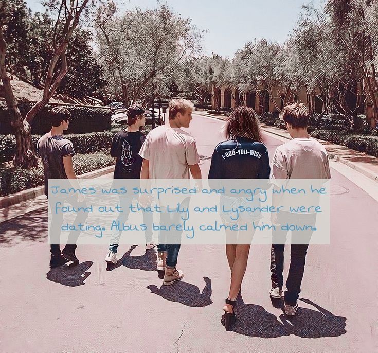 four young men walking down the street with their backs to each other, one man is holding