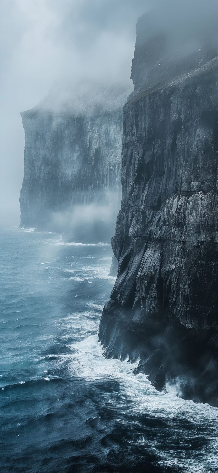 the cliffs are covered in fog and water