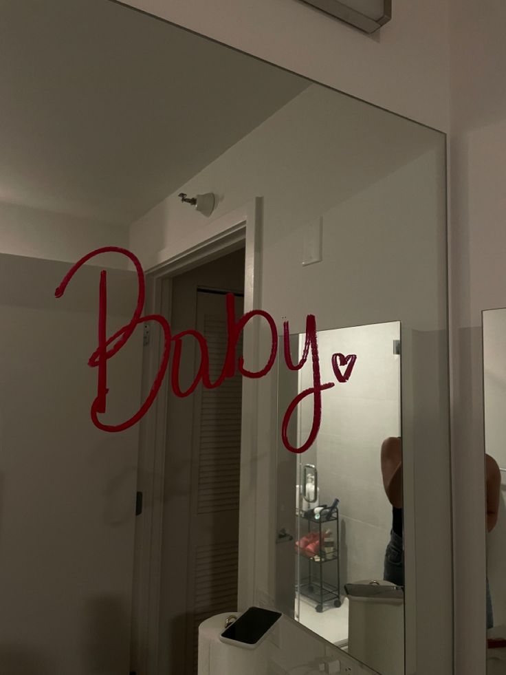 a mirror with the word baby written on it