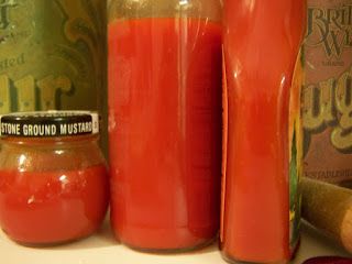 two jars with red liquid next to each other