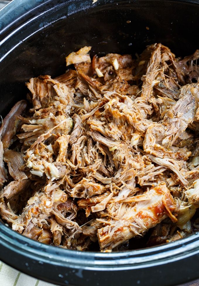 shredded meat in a slow cooker on a table