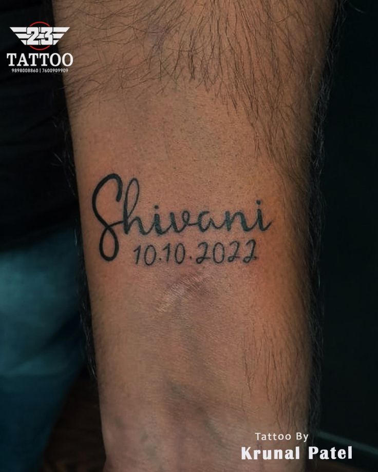 a man with a tattoo on his arm that reads shivani 1010 - 022