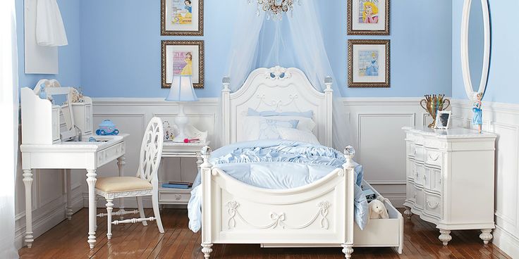 a bedroom with blue walls and white furniture