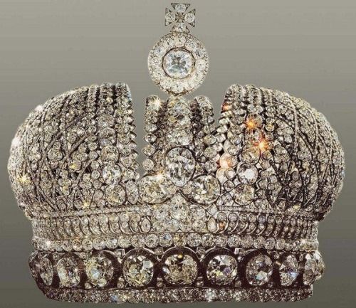 an elaborate crown with lots of diamonds on it's sides and a large white diamond in the center