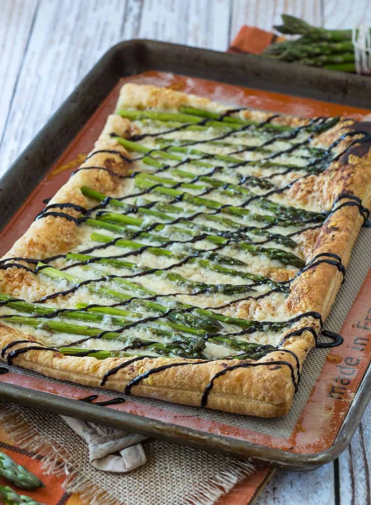 asparagus and cheese pizza on a baking sheet