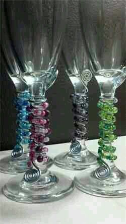 three wine glasses with different colored beads on them