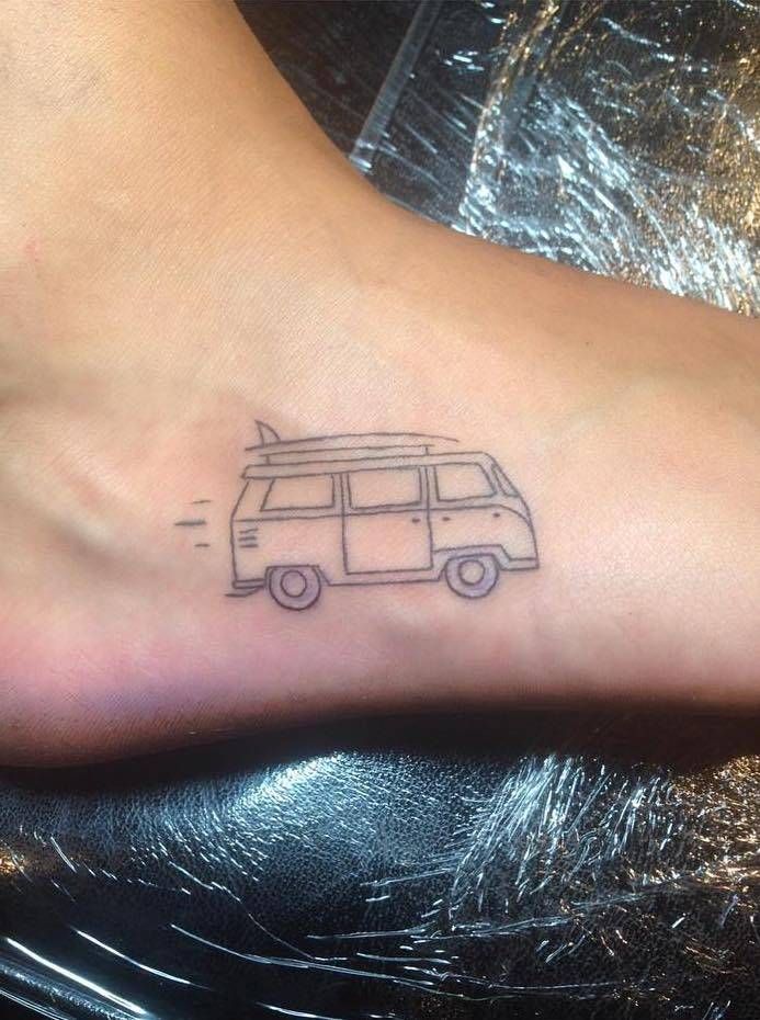 a small tattoo on the foot of a woman's foot with a van drawn on it