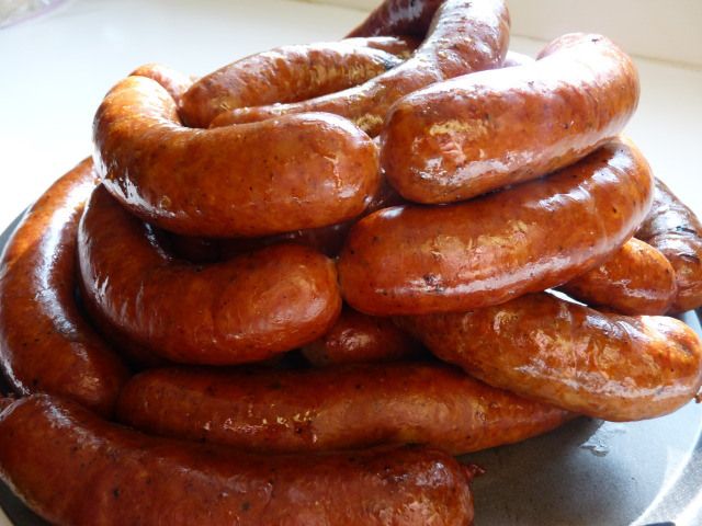 a pile of hot dogs sitting on top of a plate