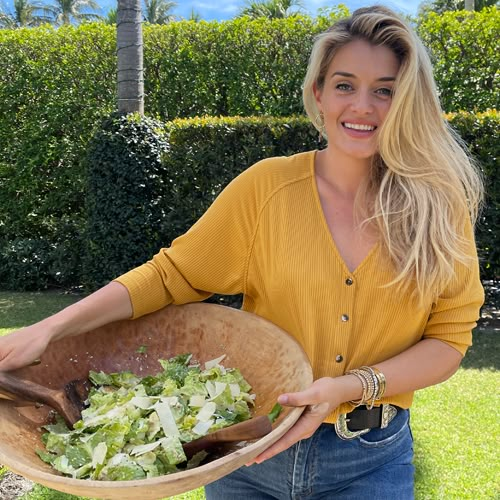 a woman holding a wooden bowl filled with salad