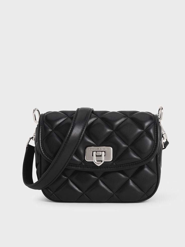 This product is made with at least 20% sustainable materials by weight. CHARLES & KEITH uses recycled, degradable, organic, and water-based materials in our eco-conscious collection.The Cressida bag is back and better than ever. Featuring a puffier and bigger quilted finish, this piece offers style and function in equal measure. Instead of the usual structured silhouette, this iteration features soft and rounded curves that make it great as a casual everyday bag. It also comes with two detachabl Trapeze Bag, Slouchy Tote, Leather Saddle Bags, Quilted Crossbody Bag, Charles Keith, Online Shopping For Women, Day Bag, Everyday Bag, Black Bag