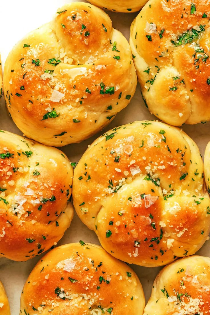 freshly baked bread rolls with parmesan cheese and chives on top, ready to be eaten