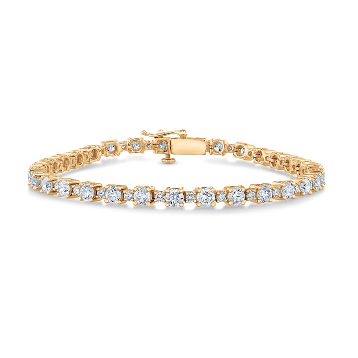 A true heirloom piece from the REEDS Exclusive ECONIC Diamond collection is sure to add an unparalleled sparkle to any ensemble. Crafted in 14k yellow gold, this timeless tennis bracelet is lined with alternating round lab grown diamonds. The diamonds are 7ctw, H in color and VS2 in clarity. This bracelet measures 7.25 inches length and 3.5mm in width. REEDS exclusive ECONIC Diamonds are lab grown in a technologically advanced facility, allowing us to offer laboratory created diamonds that posse Classic Channel Set Diamond Bracelet For Wedding, Classic Channel Set Diamond Bracelet, Yellow Gold Tennis Bracelet With Brilliant Cut For Anniversary, Classic Yellow Gold Diamond Bracelet With Prong Setting, Classic Diamond Tennis Bracelet With Channel Set, Classic Diamond Bracelet With Channel Set, Classic Diamond Tennis Bracelet Channel Set, Classic Round Cut Channel Set Diamond Bracelet, Timeless Channel Set Tennis Bracelet For Anniversary