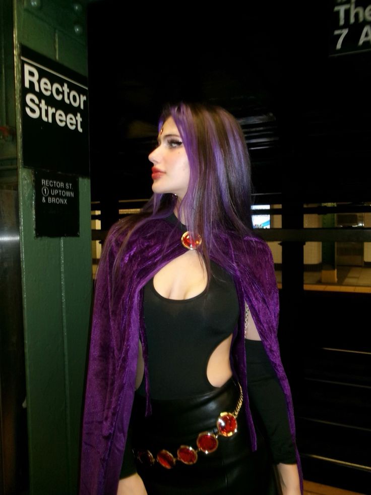 a woman with purple hair wearing a black outfit