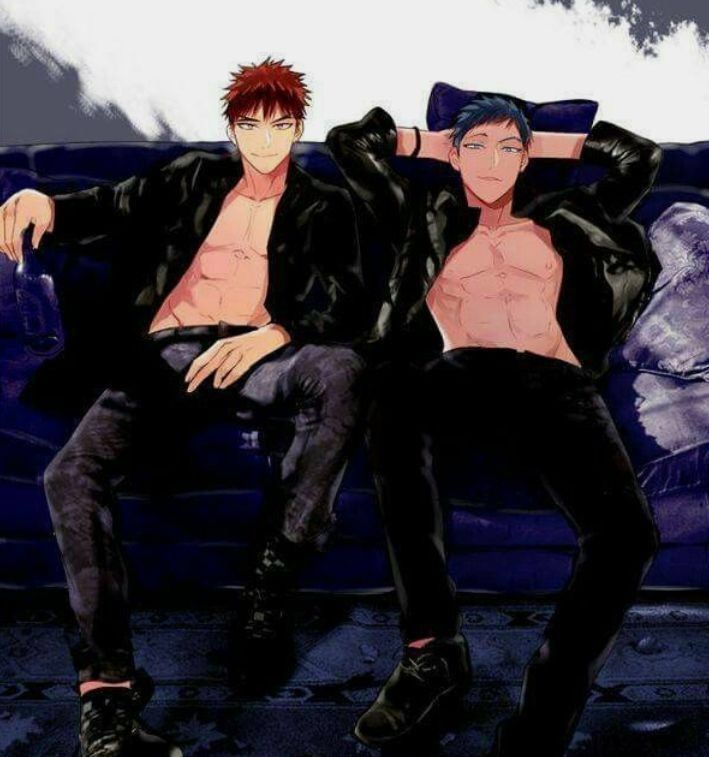 two men sitting on a couch with their arms around each other's backs, one man has red hair and the other wears black pants