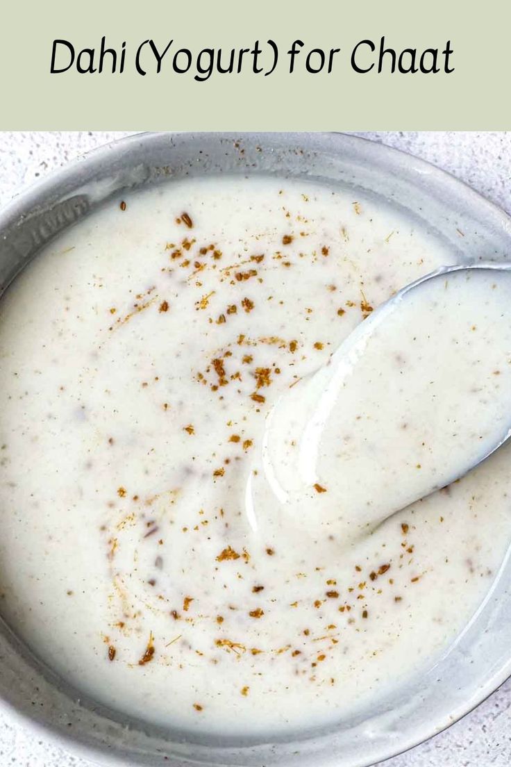 a bowl of yogurt with a spoon in it and the words, how to make yogurt for chaat