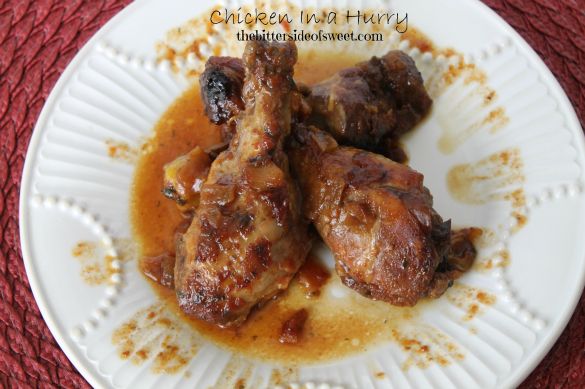 two pieces of meat sitting on top of a white plate covered in gravy