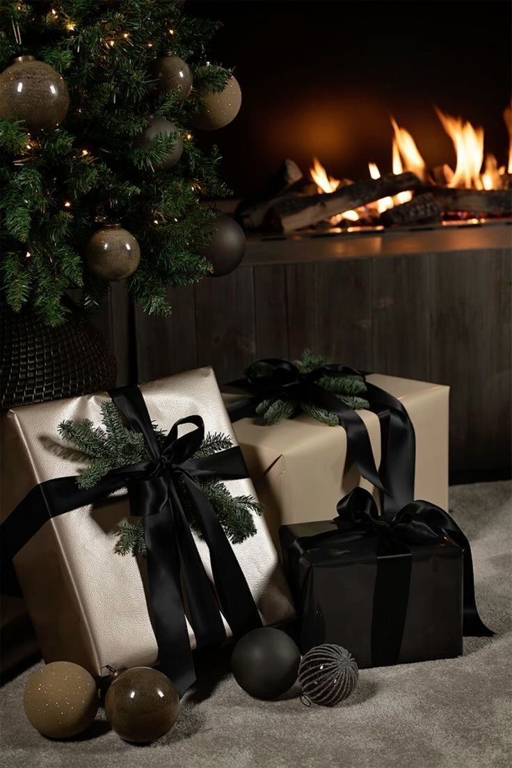 presents under a christmas tree in front of a fireplace with lit balls and baubs