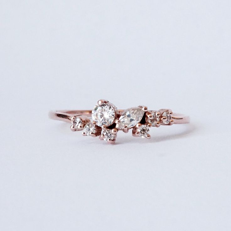 The Pixie Cluster ring is made in your choice of CZ's or natural diamonds. Pair it with our Meghan Stack Ring for the ultimate delicate look. This ring is designed and made in NYC. 14K solid gold Cz or natural diamonds 1.2mm ring band Natural diamonds version: Approx. 0.2ct. VS~SI clarity. **This item is specially made for you. Please allow 1-2 week lead time. Shipping:Domestic: Free standard shipping within the U.S.International: Free standard shipping for orders over $200 Customization:- Inter Dainty Cluster Ring, Dainty Rose Gold Diamond Ring, Rose Gold Cluster Ring With Single Cut Diamonds, Rose Gold 14k Cluster Ring With Single Cut Diamonds, Delicate Rose Gold Diamond Ring With Single Cut Diamonds, Dainty Rose Gold Round Cut Cluster Ring, Rose Gold Sterling Silver Rings With Single Cut Diamonds, Delicate Rose Gold Sterling Silver Diamond Ring, Delicate Rose Gold Diamond Promise Ring