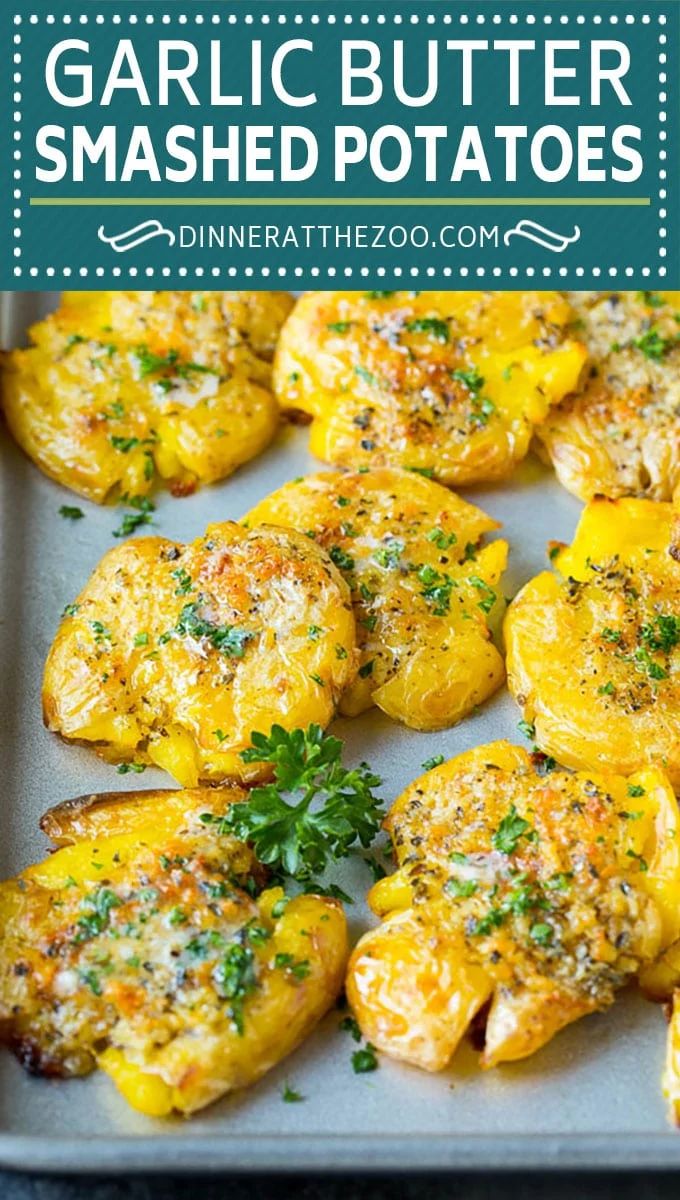 garlic butter smashed potatoes on a baking sheet with parsley sprinkled on top