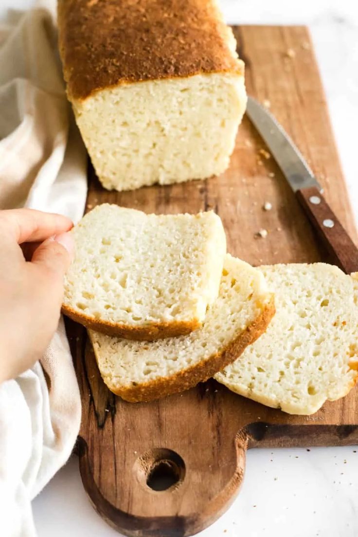 sliced loaf of white bread sitting on top of a cutting board