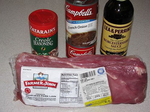 meat, seasoning, and other ingredients are laid out on the counter