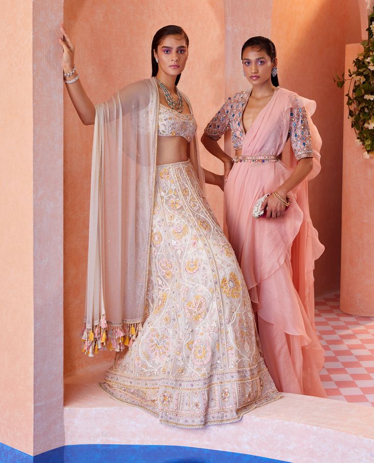 Editor's Note This set features a peach net embroidered blouse paired with a chiffon-organza draped ruffle saree and an embroidered belt. The blouse is intricately embroidered with delicate threadwork and embellished with sequins, while the saree features a ruffled design and a beautiful combination of peach and organza. The embroidered belt adds a touch of elegance and completes the overall look. It is a perfect choice for any special occasion or event. Fabric: Blouse: net, saree: chiffon/ orga Elegant Peach Georgette Lehenga, Peach Georgette Pre-draped Saree For Wedding, Peach Pre-draped Traditional Saree, Peach Georgette Blouse Piece For Wedding, Elegant Peach Choli For Reception, Peach Pre-draped Saree For Wedding, Designer Wear Peach Lehenga, Peach Pre-draped Saree For Diwali, Peach Sharara With Sheer Dupatta