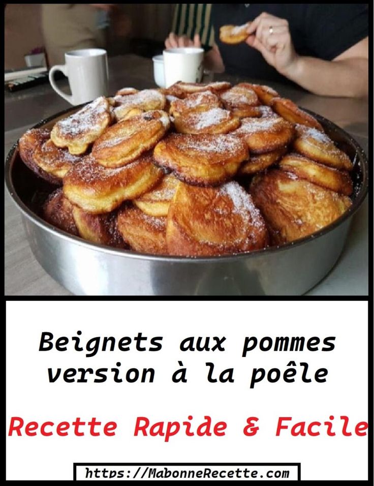 a pan filled with lots of powdered sugar covered pastries on top of a table