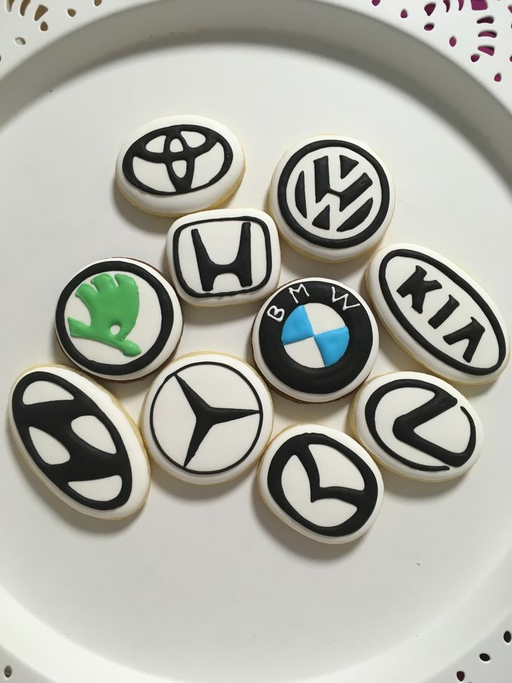 the cookies are decorated with bmw emblems on white icing and black frosting