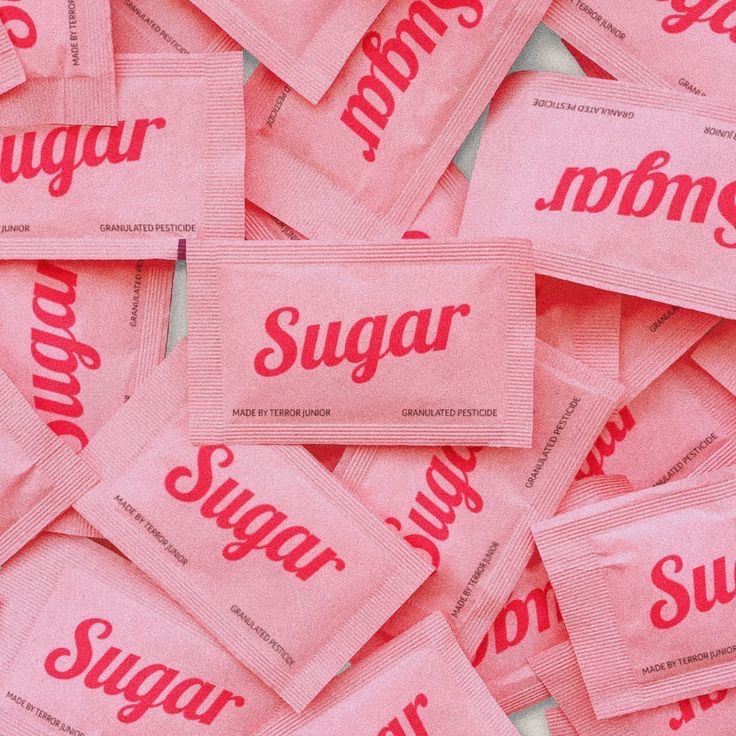 a pile of sugar packets sitting on top of each other with the word sugar on them