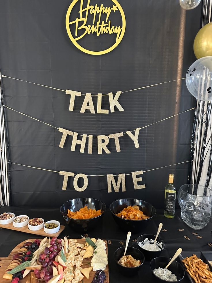 a table topped with lots of food next to a sign that says talk thirty to me