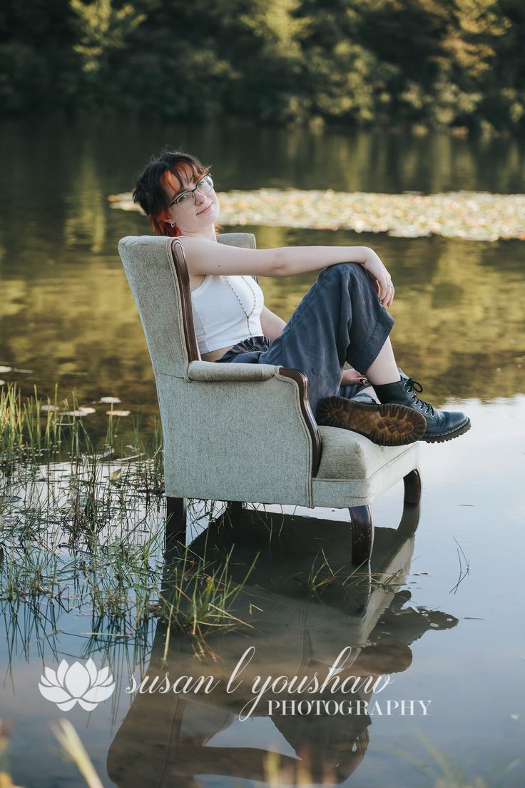 a woman is sitting on a chair in the water with her legs crossed and eyes closed