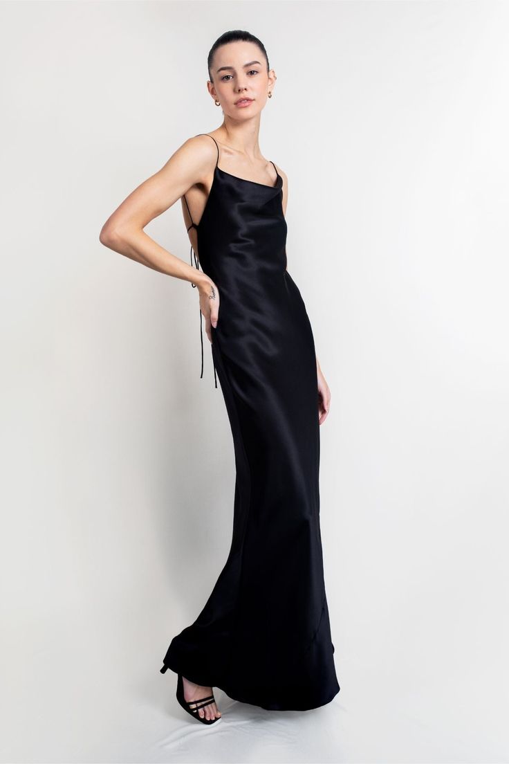 The Whitney gown is striking in its simplicity. Handcrafted from Italian 19 momme silk-satin that's cut on the bias for a flawless drape, it has delicate straps that tie at the low, scooped back and falls to a floor-grazing hem. The draped front neckline elegantly frames the décolletage. This dress is made to order. Please allow 2-3 weeks from order date to shipping date. Sleek Black Bias Cut Dress, Elegant Black Bias Cut Gown, Black Backless Bias Cut Slip Dress, Sleek Bias-cut Backless Evening Dress, Black Silk Bias-cut Evening Dress, Evening Gown Black, Black Tie Wedding Guest Dress, Backless Gown, Satin Evening Gown