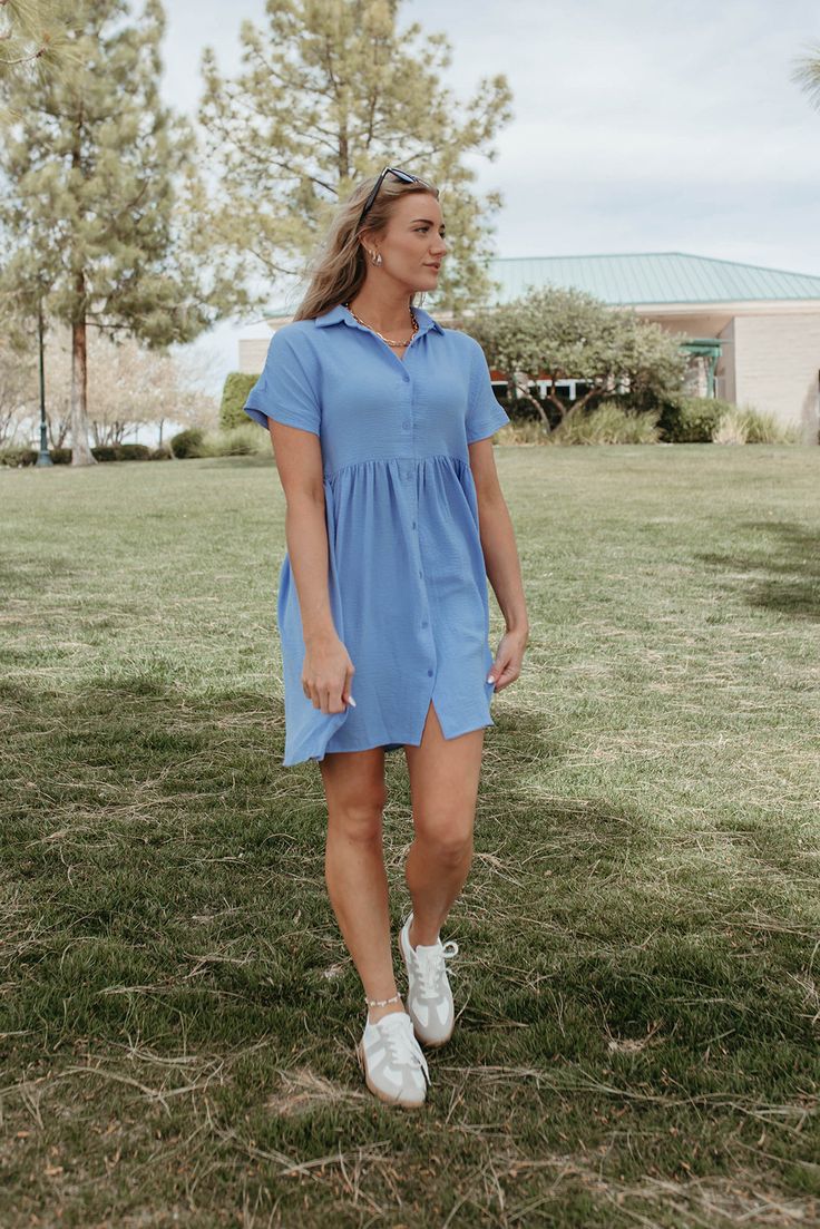 Lighten up your spring and summer wardrobe with THE HEIDI DRESS IN SOFT CHAMBRAY. This flowy blue dress is perfect for sunny days, featuring a collared neckline for a cute touch. Stay cool and stylish in this must-have piece. Paired with THE CASUAL SNEAKERS IN GREY Collared Button up Textured fabric 95% polyester 5% spandex Runs true to size. X-Small (00-2), Small (2-4), Medium (4-8), Large (8-12), X-Large (12-16) Model is 5'9" wearing a size small. Length (shoulder to hem): X-Small 35.5", Small 36", Medium 36.5", Large 37", X-Large 37.5" To view our return policy click here! Check out our try on video below!\ Collared Summer Beach Dress, Summer Daytime Knee-length Shirt Dress, Collared Summer Dresses For Beach, Summer Beach Dress With Collar, Daytime Midi Length Summer Shirt Dress, Knee-length Summer Shirt Dress For Daytime, Daytime Knee-length Summer Shirt Dress, Light Blue Sundress For Summer Daywear, Short Sleeve Shirt Dress For Summer Brunch