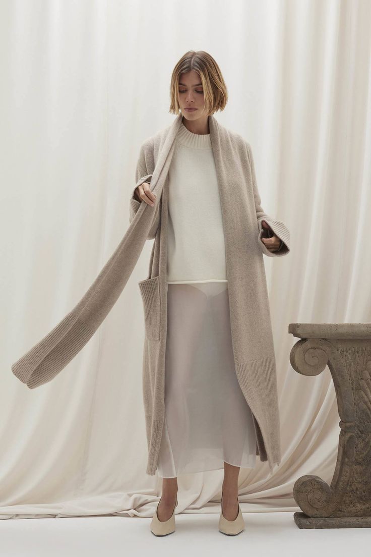 Elevate your cold-weather wardrobe with the Georgina longline cardigan. This open-front design is highlighted by its built-in scarf and ribbed cuffs, offering both warmth and sophistication. Crafted from plush cashmere, it‚Äôs a timeless piece with modern flair. 941 grams of 100% pure cashmere in 5-gauge knit Made in Italy Longline cardigan Scarf accent Open front Ribbed trim Slits at side 45" length (size small) Dry Clean Only All sale items are FINAL SALE. Elegant Winter Loungewear Outerwear, Long Sweater Coat For Winter, Long Coat Cardigan For Winter Loungewear, Winter Long Coat Cardigan For Loungewear, Winter Cashmere Cardigan For Loungewear, Long Cashmere Sweater Coat For Work, Chic Long Cashmere Cardigan, Long Sweater Coat For Winter Daywear, Winter Long Sweater Coat For Daywear