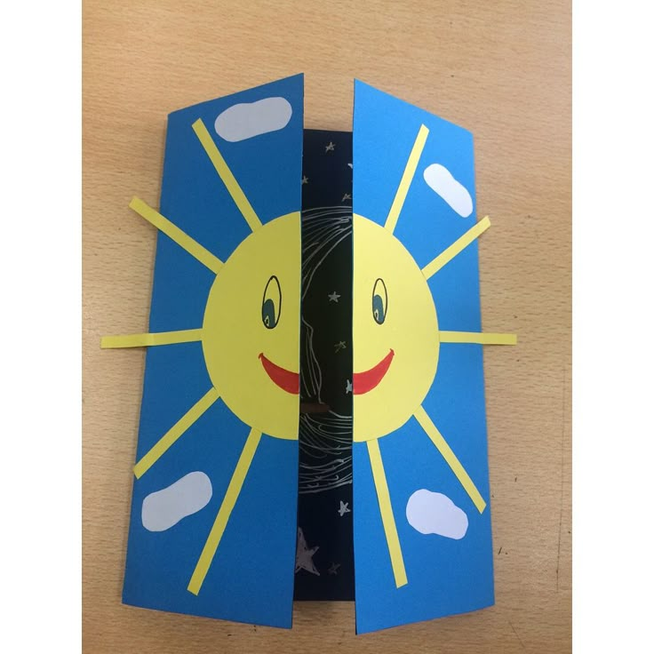 an open book with the pages cut out to look like a sun and moon on it