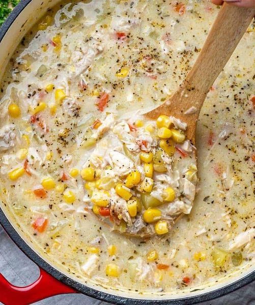 a pot filled with chicken and corn soup