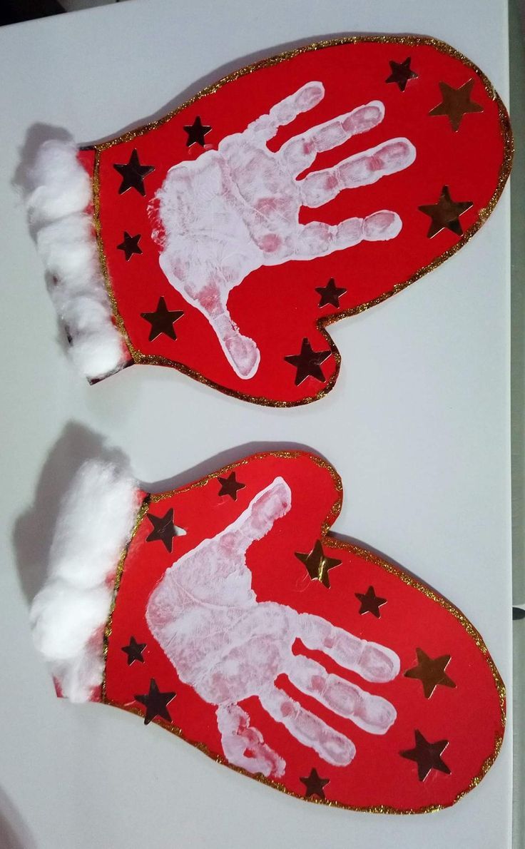 two handprinted red mittens with stars on them, one is white and the other is red